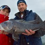Father and Son with Black Sea Bass
