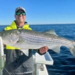 Captain Bobby Rice with Striped Bass of Reel Deal Fishing Charters
